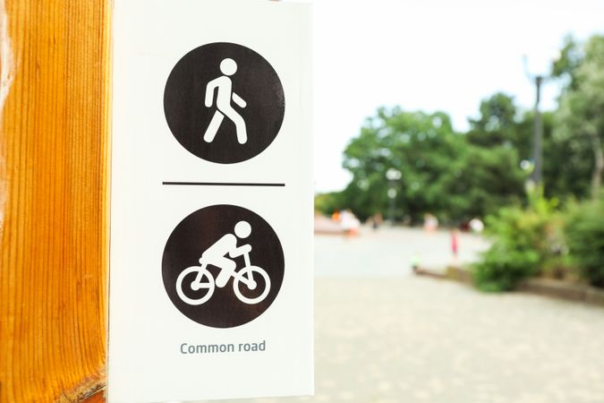 Sign for pedestrians and cyclists in park, space for text