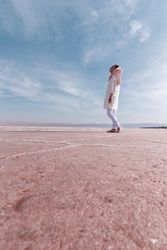 Thoughtful relaxed tourist enjoying unusual scenery of pink salt lake