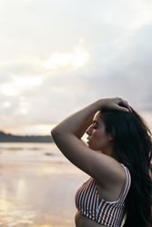 Young woman watching sunset on the beach