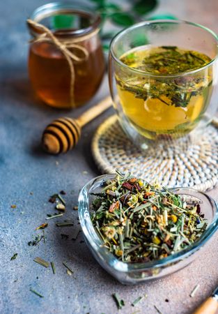 Loose leaf chamomile tea in heart container with honey