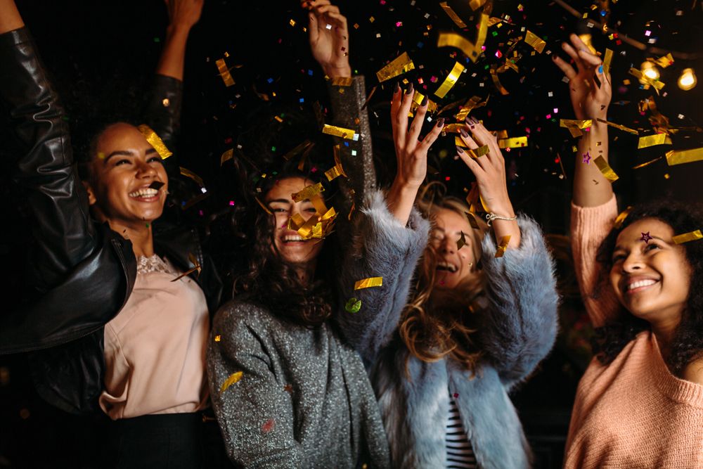 Multi-ethnic group of female friends celebrating at party on a patio