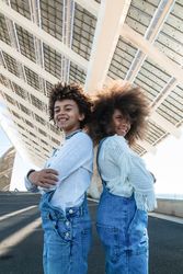 Cheerful Black teenagers in denim outfits