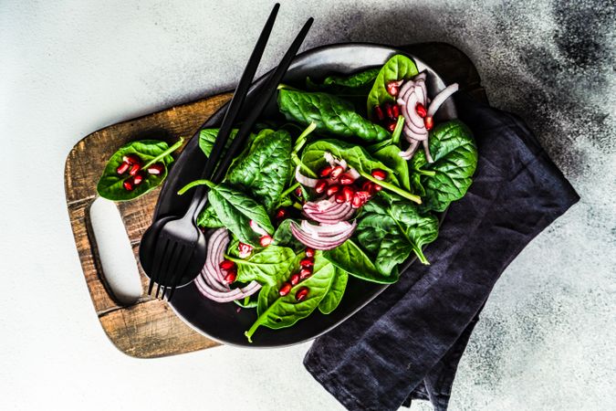 Top view of fresh organic salad with spinach and pomegranate