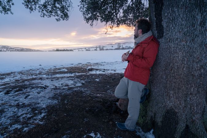 Man playing guitar under tree