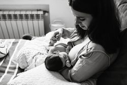 Mom breastfeeding at home