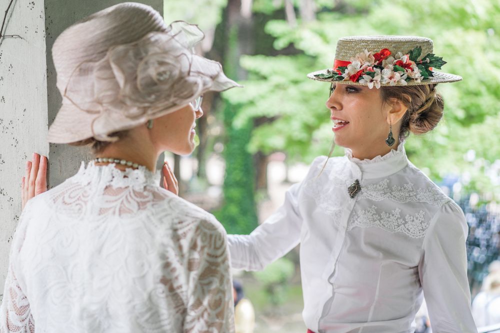 Vintage female friends speaking in garden