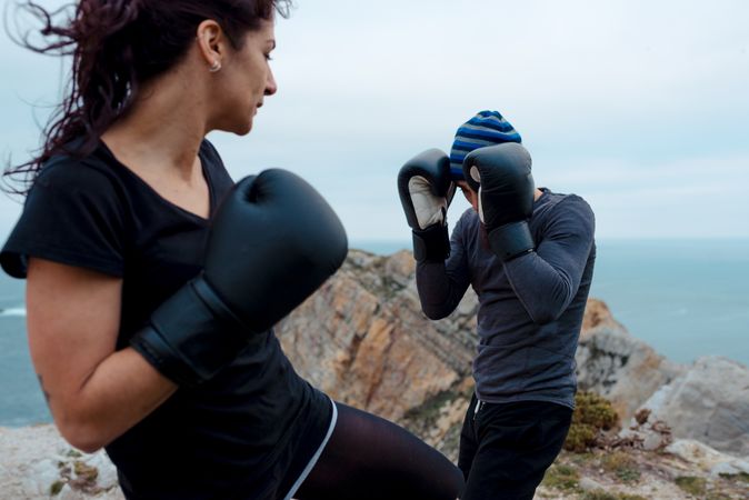 Boxers exercising on cliff