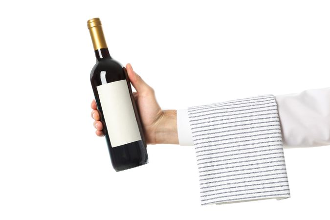 Male hand holding bottle of wine, isolated on light background