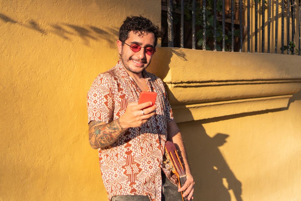 musician checking his cell phone