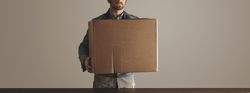 Man holding cardboard box, wide