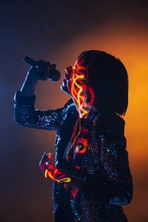 Stylish woman singing on stage