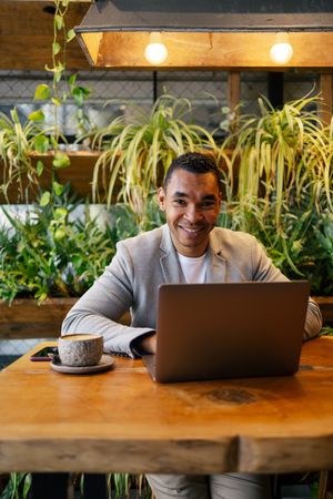 Man working on laptop at cafeteria