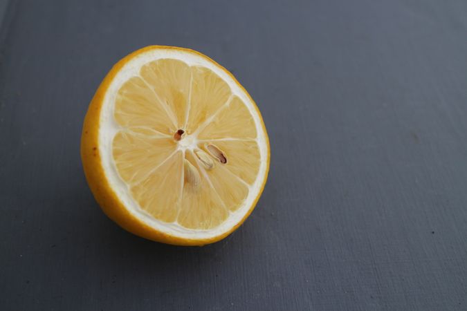 Lemon slice in dark background, with copy space