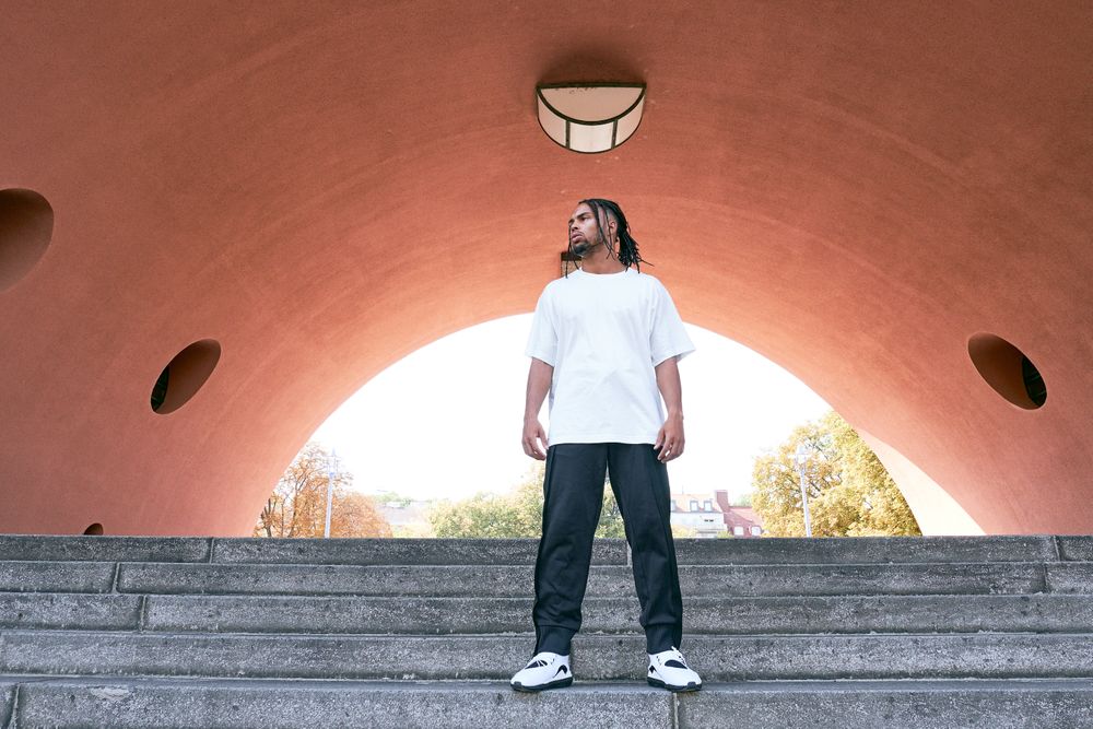 Trendy Black man near modern arch