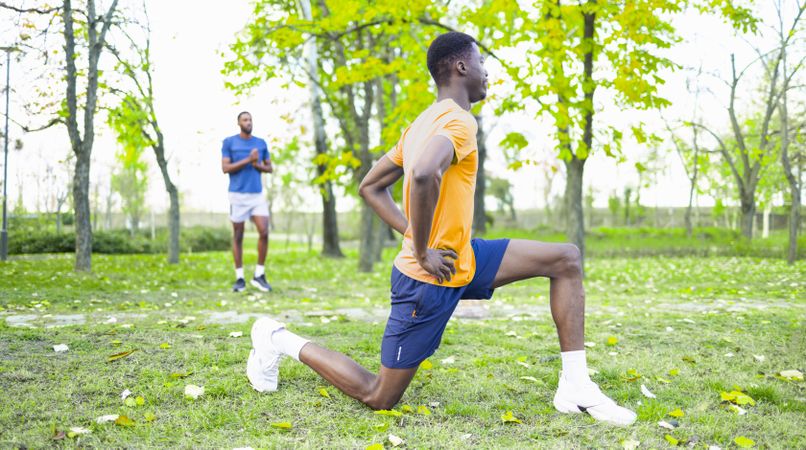 Black Friends Stretching in Early Morning Spring Light for Wellness and Fitness.