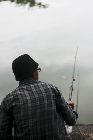 Rear of male fishing