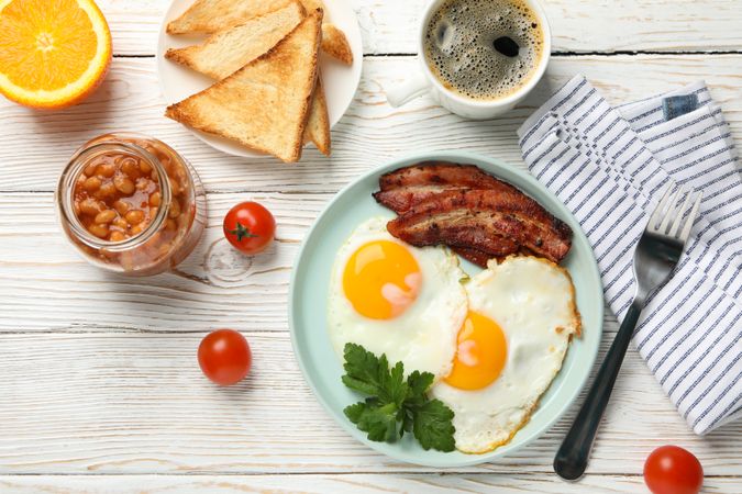 Full breakfast with eggs, beans, bacon, fruit and coffee