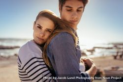 Romantic couple standing near the ocean together 41XnZ5