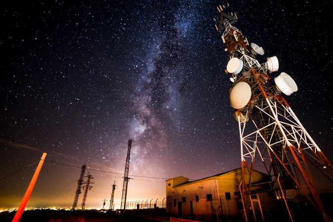 Amazing view of transmission towers against Milky Way in night sky