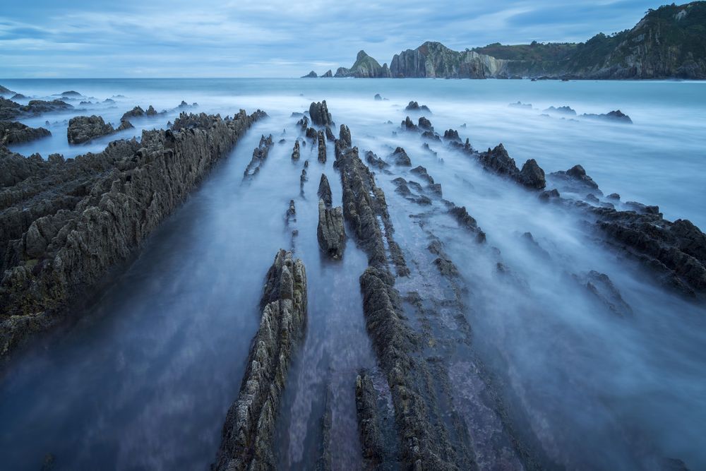 Foggy landscape of Playa de Gueirua rock seashore