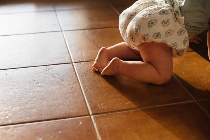 Baby crawling on all fours on floor