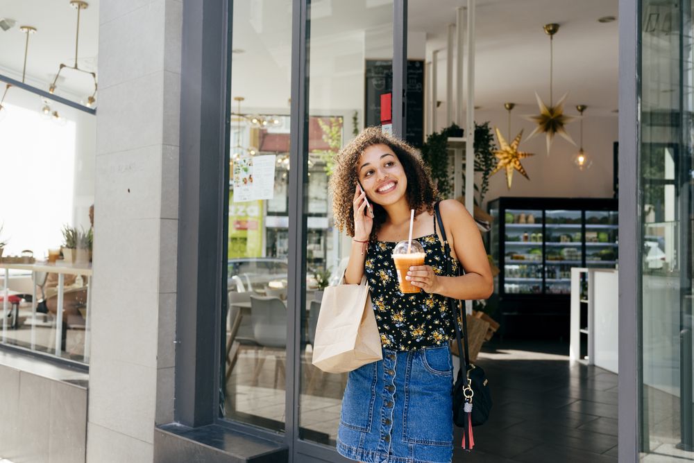 Cheerful woman leaving restaurant