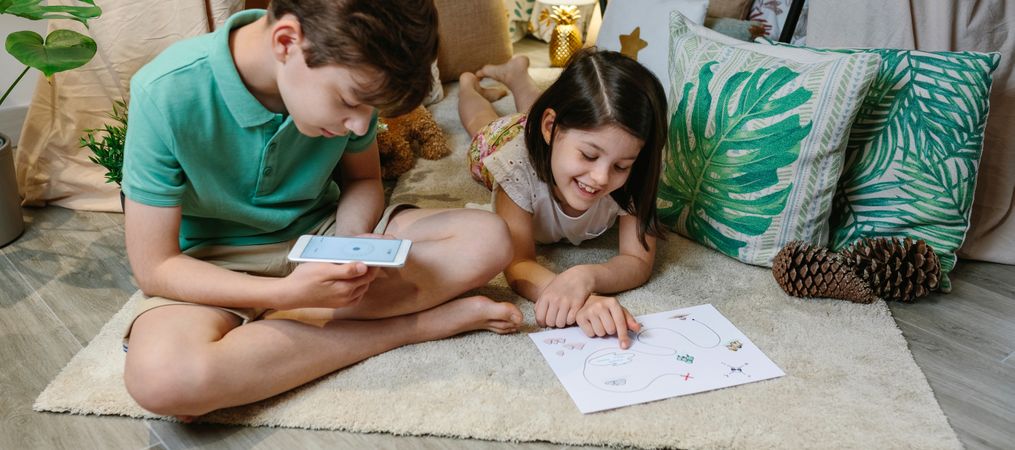 Children playing in a cozy diy tent at home