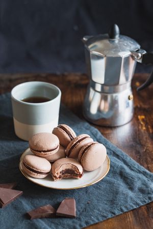 Chocolate macarons served with coffee