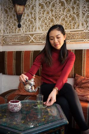 Asian woman enjoying Arabic tea
