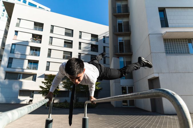 Businessman doing parkour in city district