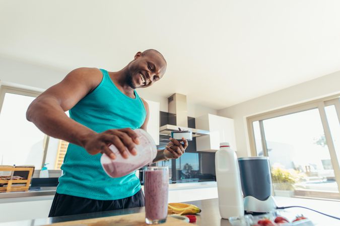 Man making milk shake in kitchen