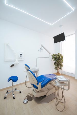 Empty dental chair with tools awaiting client