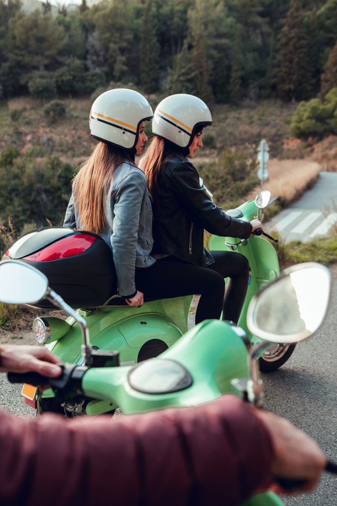 Young people riding motorcycles on city road