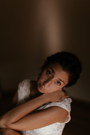woman sitting in dark room