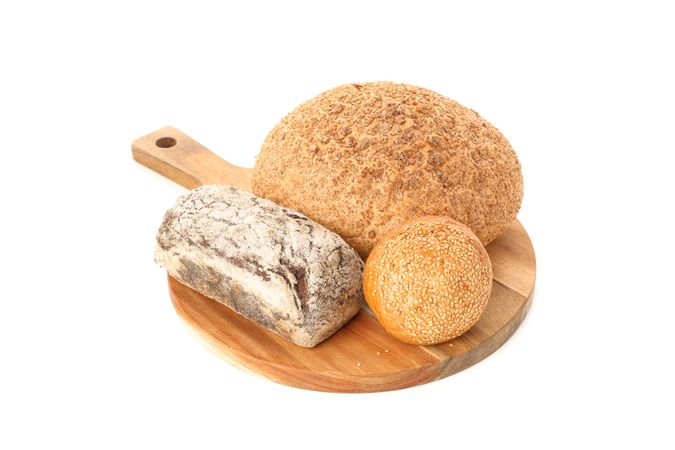Bakery products on cutting board isolated on blank background