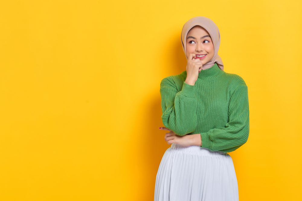 Woman in headscarf with look of anticipation