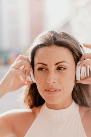 Brunette listening to music in sunlight