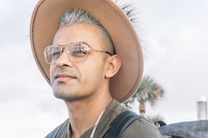 Young man expressing joy and posing for a photo in glasses