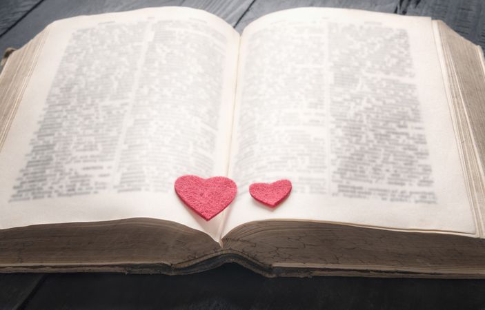 Antique book and two hearts on it
