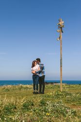 Couple kissing embraced by a direction sign