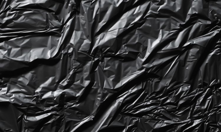 dark crumpled and creased plastic poster texture background