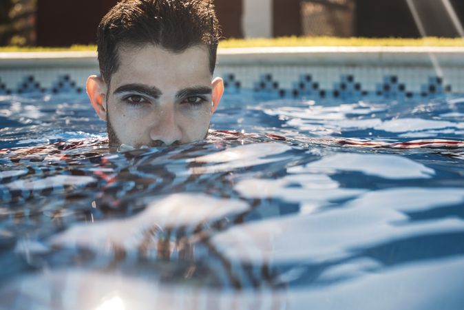 Dressed man in swimming pool