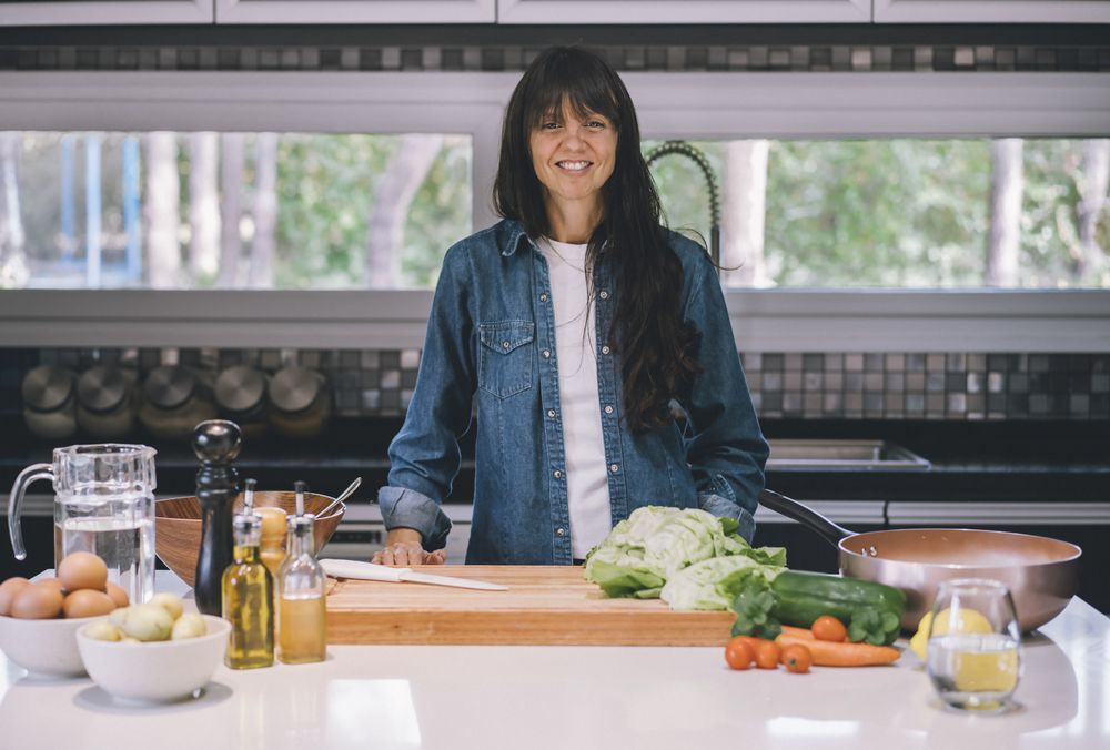 woman housewife preparing meal while looking at camera