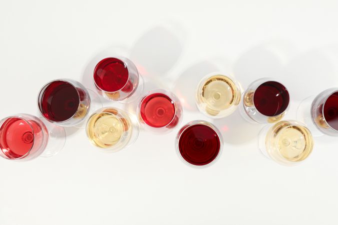 Flat lay composition. Glasses with different wine on blank background, top view