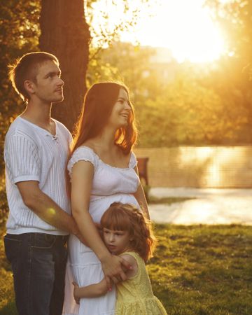 Side view of young family in park at magic hour