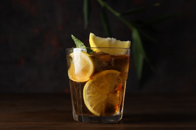 A glass of cold tea on a dark background
