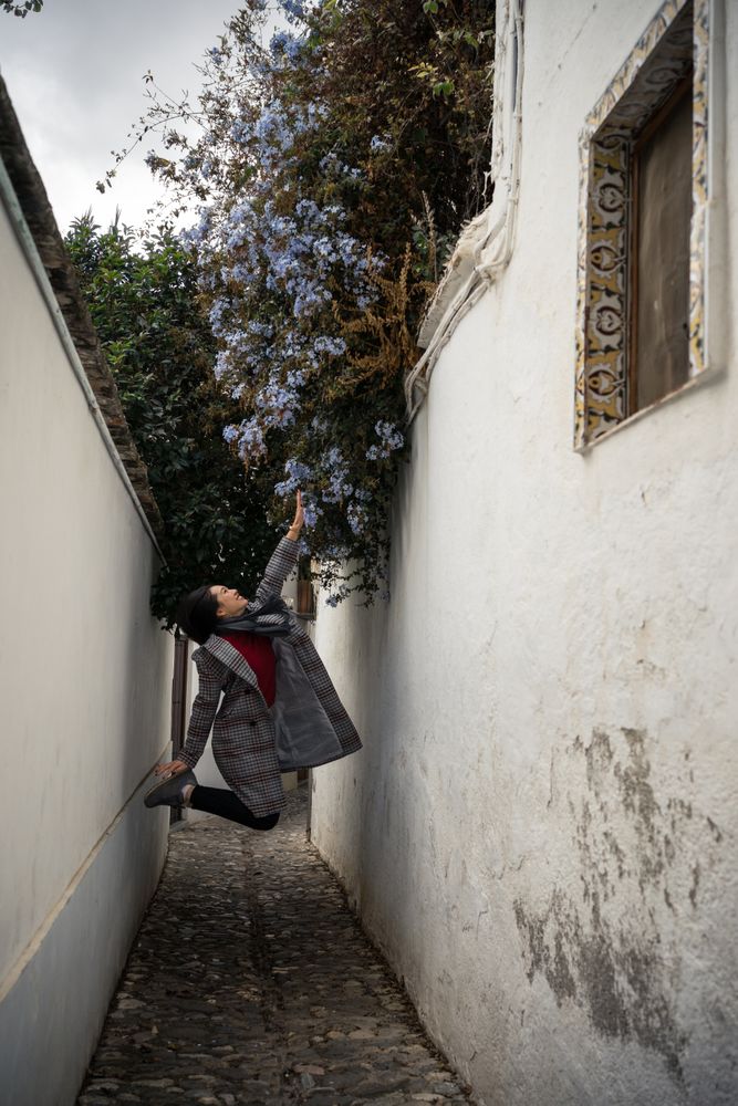 Joyful female tourist in casual wear amid city street