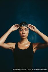 Confident woman in swimming costume on dark background 5rZLM5