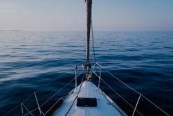 Sailboat in sea at dusk