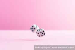 Two dice over pink background 5z9YQ0